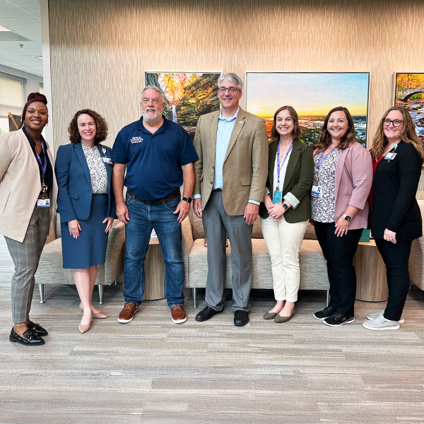 Illinois State legislators posing with staff members of The Quad Cities Rehabilitation Institute