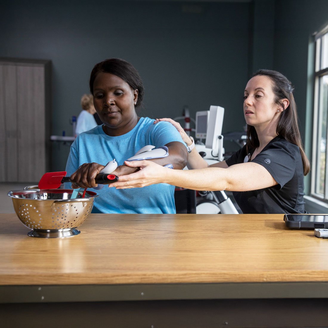 Nurse helping a patient use a Bioness device