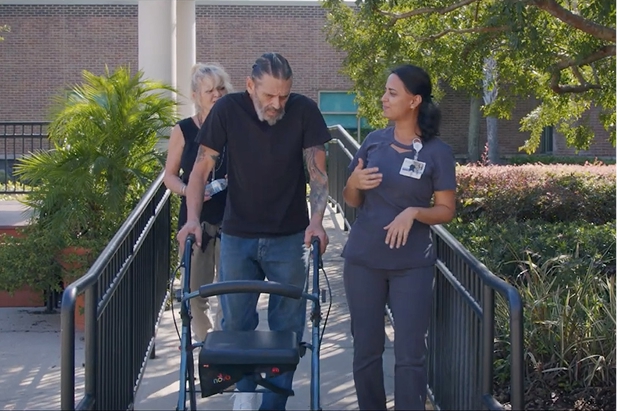 Veteran works with rehabilitation therapists during inpatient rehabilitation focused on walking and independence.