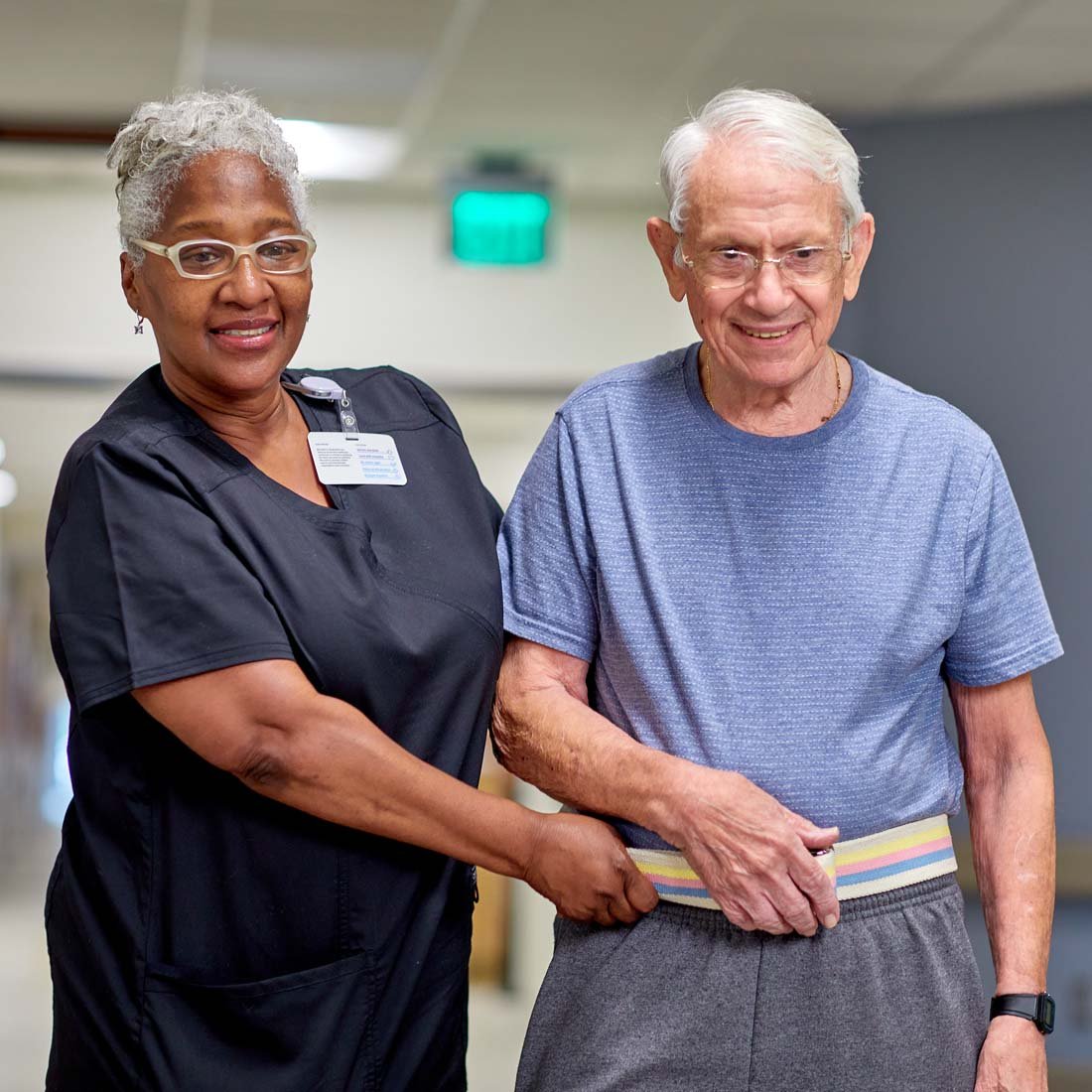 A nurse helping a patient walk