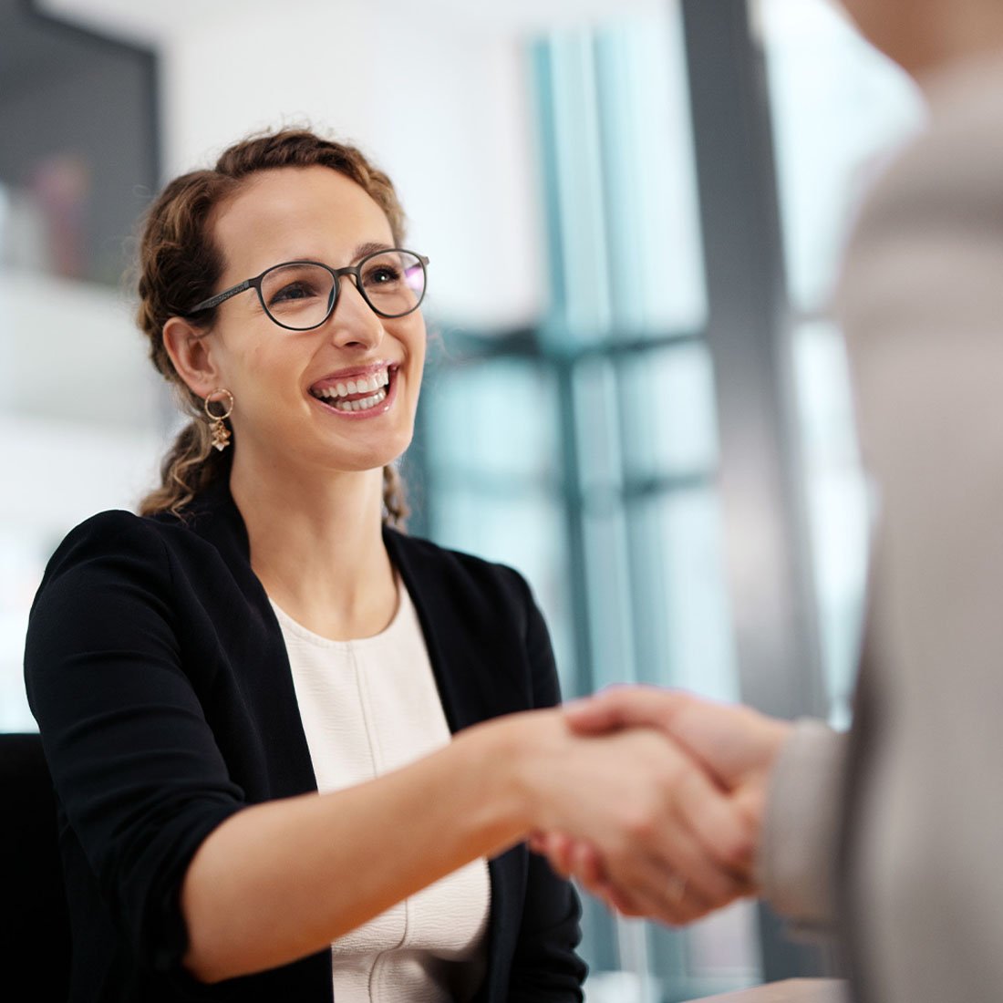 Woman shaking hands with an associate
