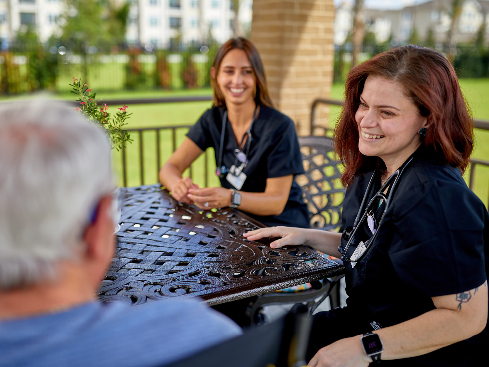 Intern and other therapist talking with a patient
