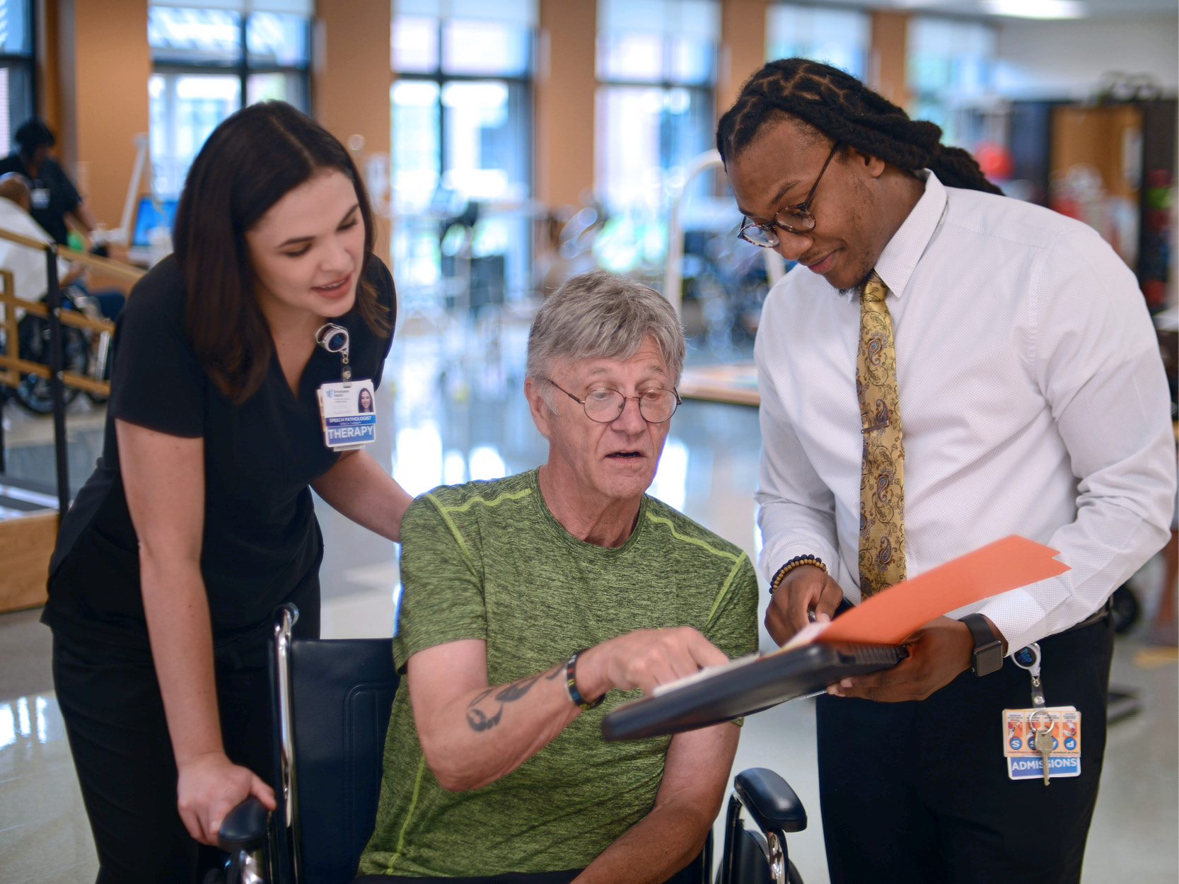 case manager, patient and therapist talking