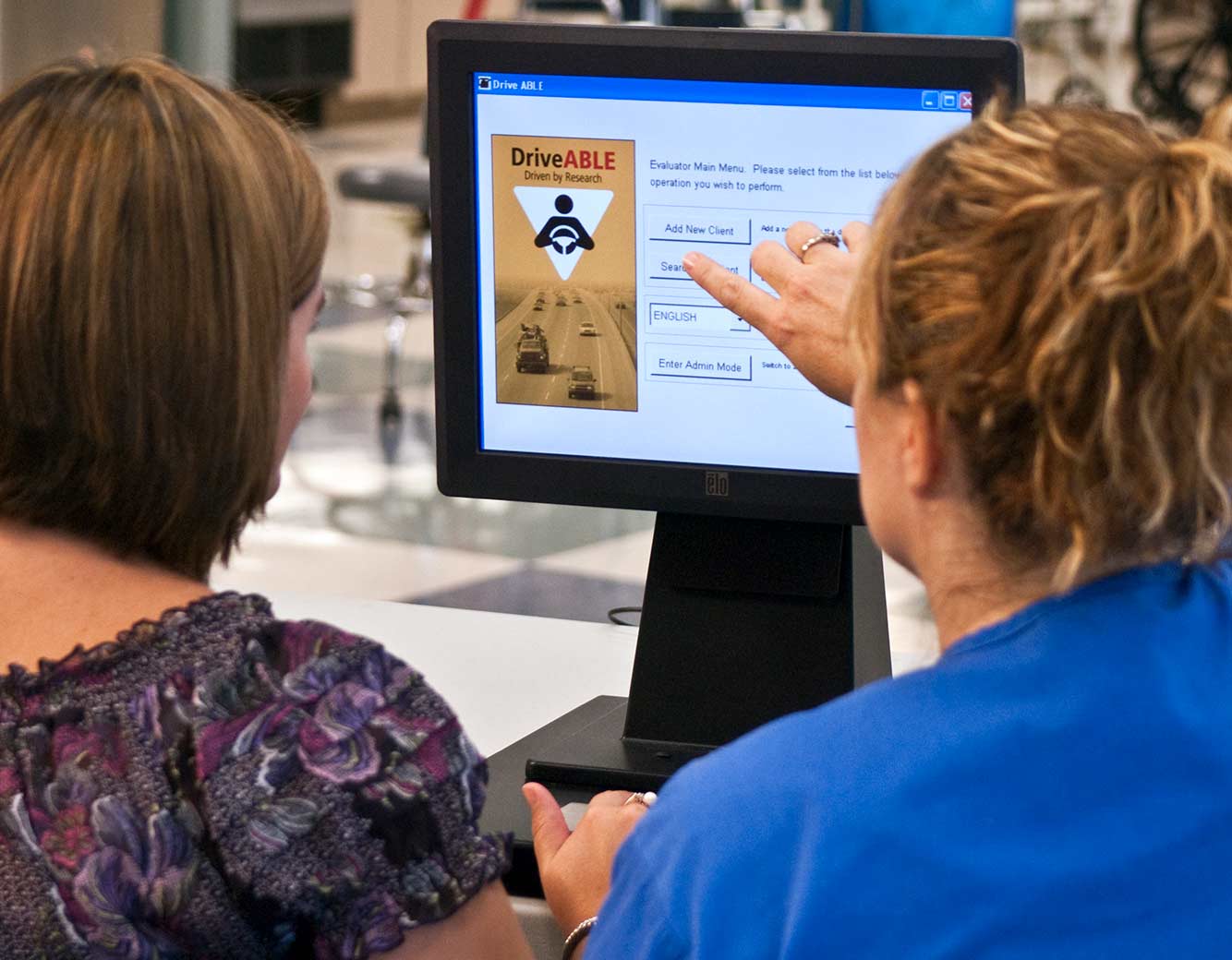 Therapist helping a patient use DriveABLE software