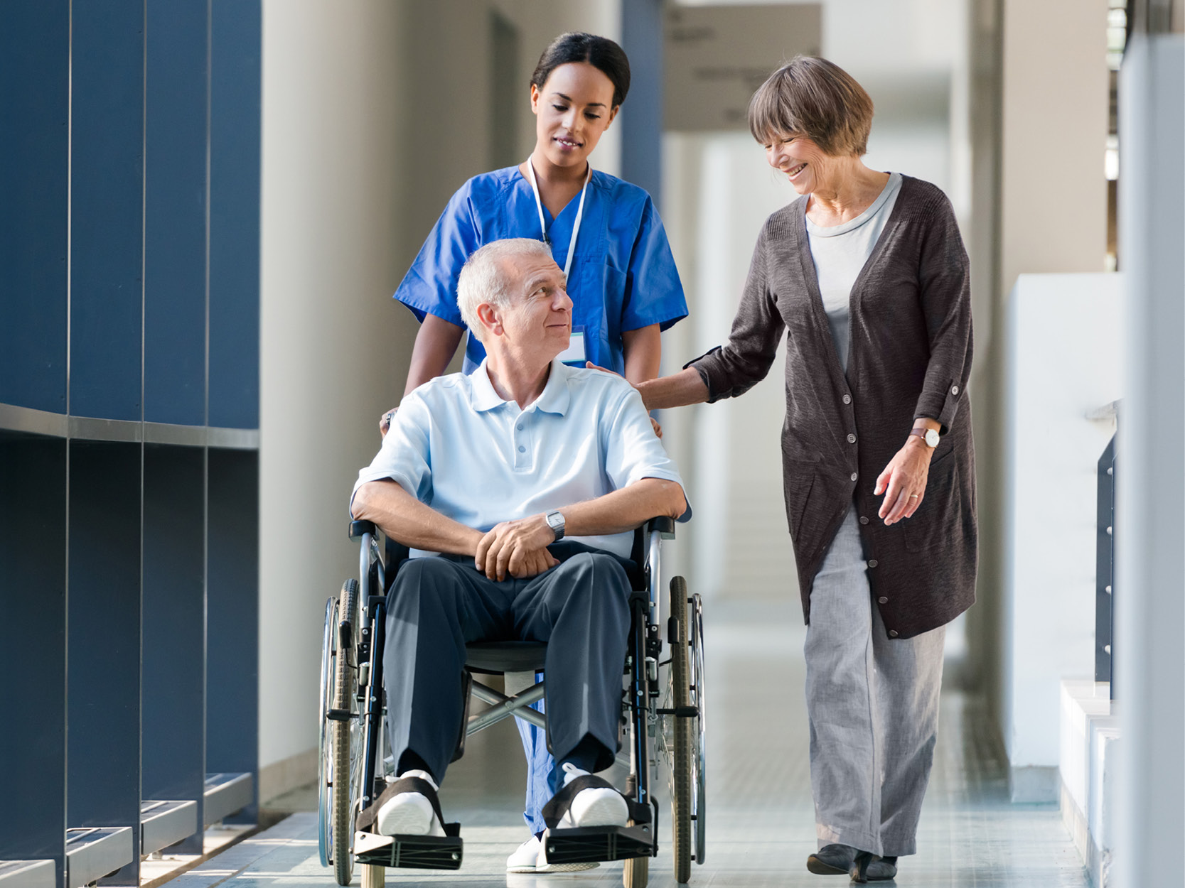 patient, nurse and caregiver in the hall