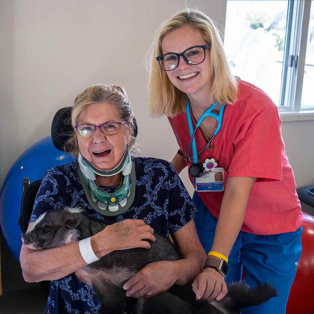 A patient holding a therapy pig