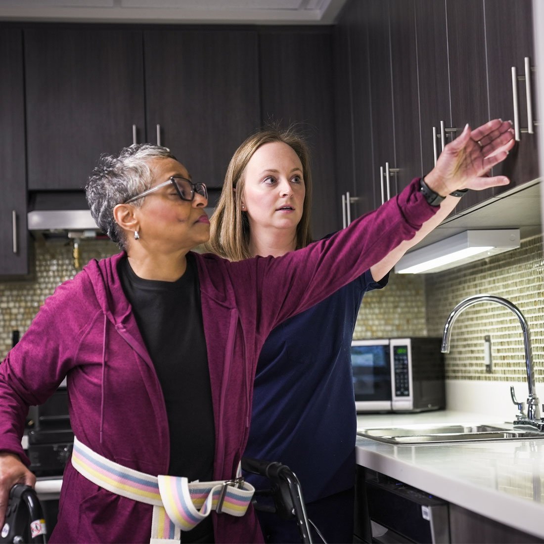 A patient reaching for a cabinet