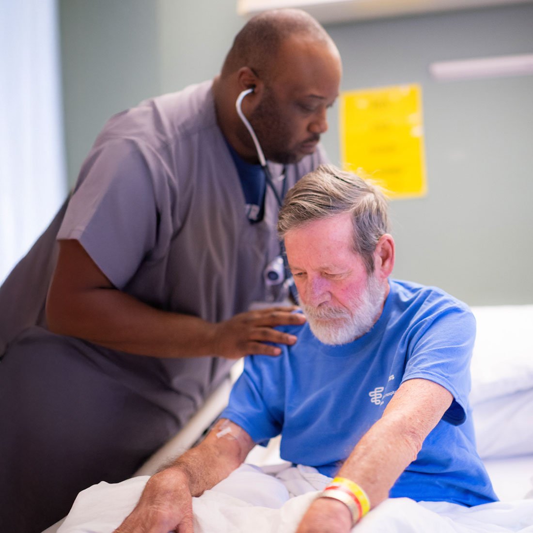Nurse listening to a patient's lungs
