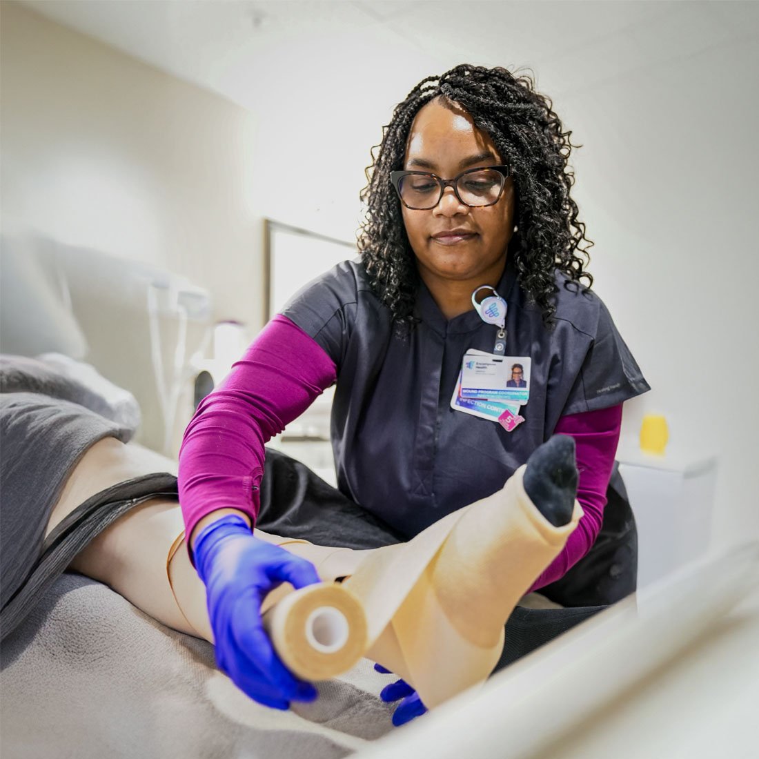 A nurse dressing a wound