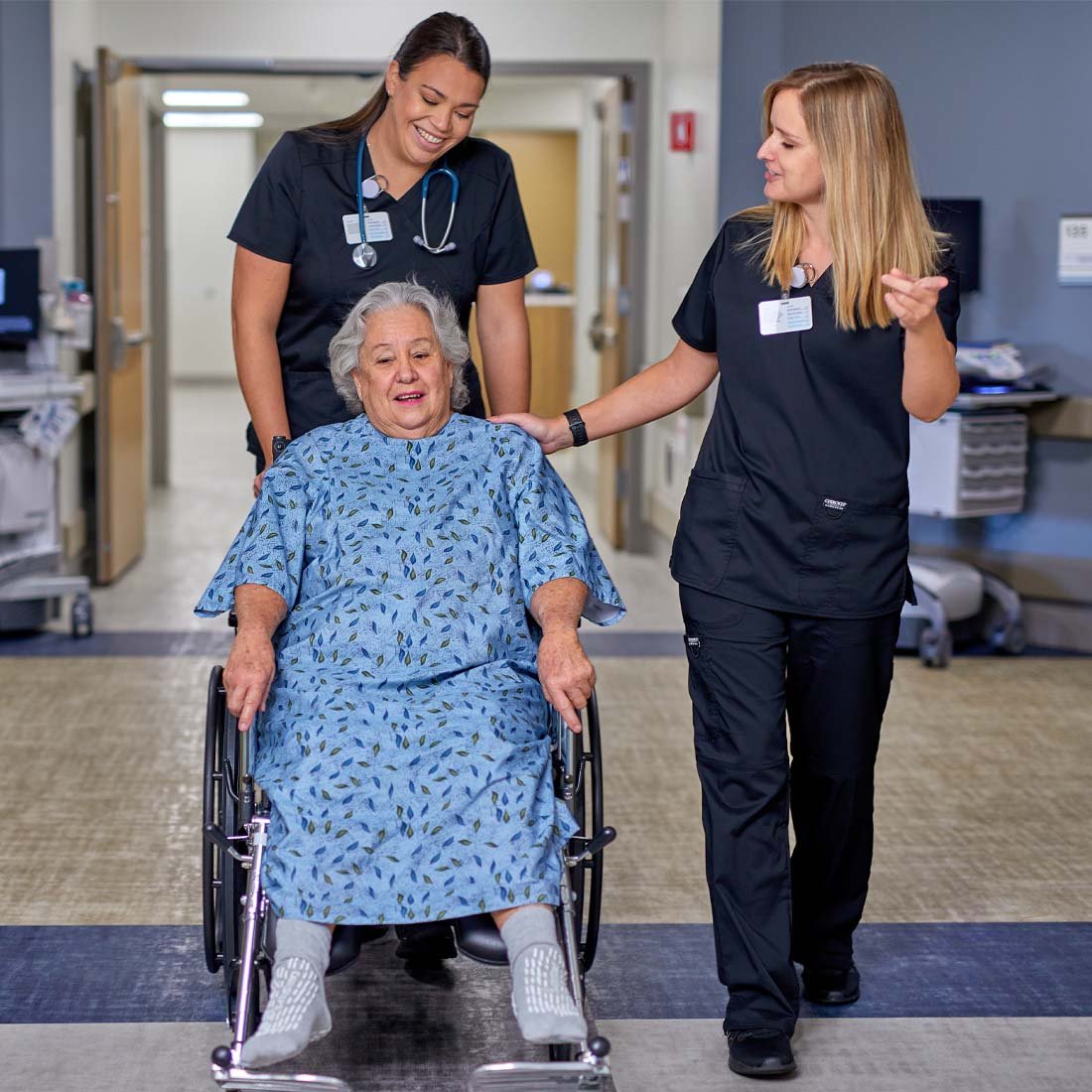 Nurses pushing a patient in a wheelchair