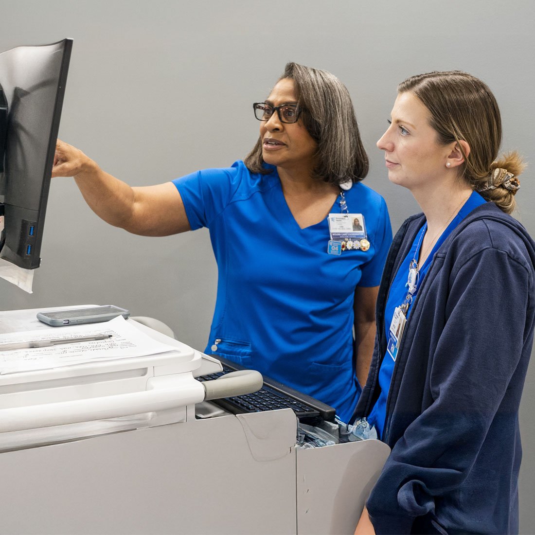 Two nurses looking at a monitor