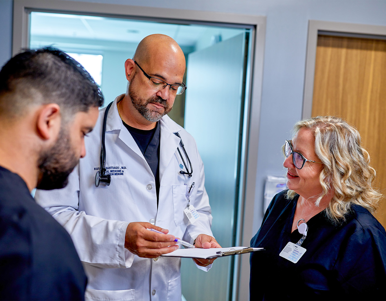 Doctor reviewing a document with rehabilitation nurses