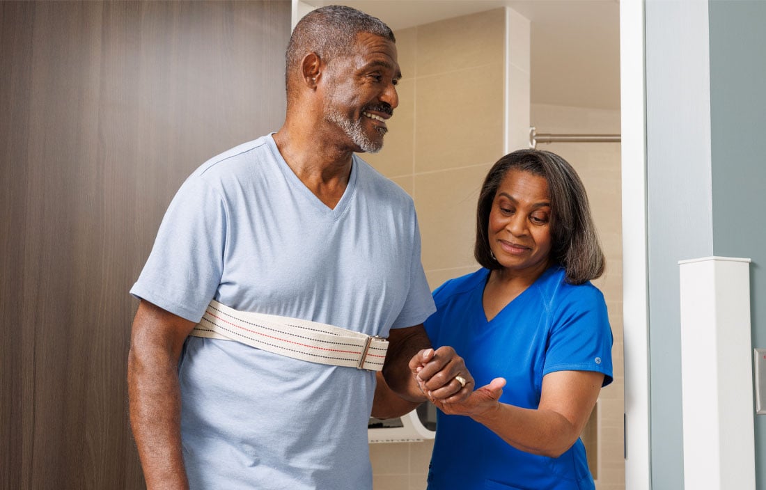 Nurse helping a patient walk