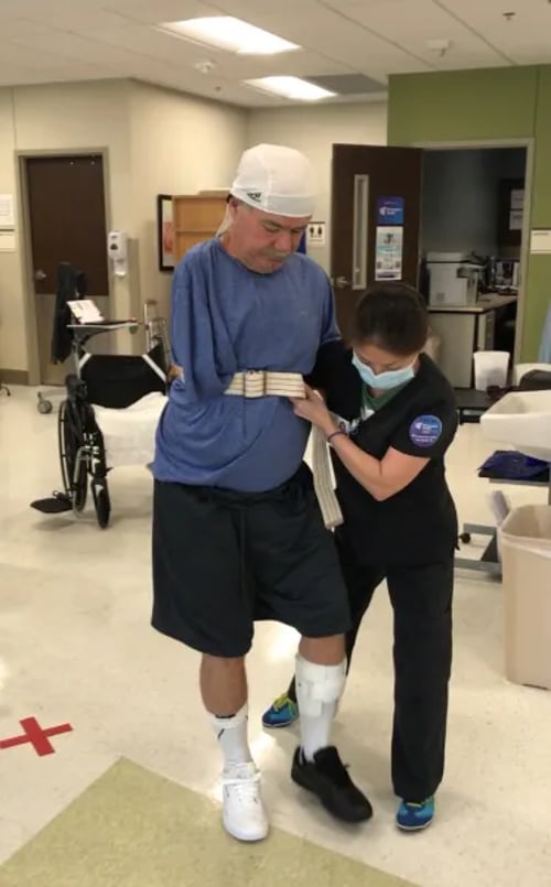 Victor relearning how to walk with Encompass Health therapist