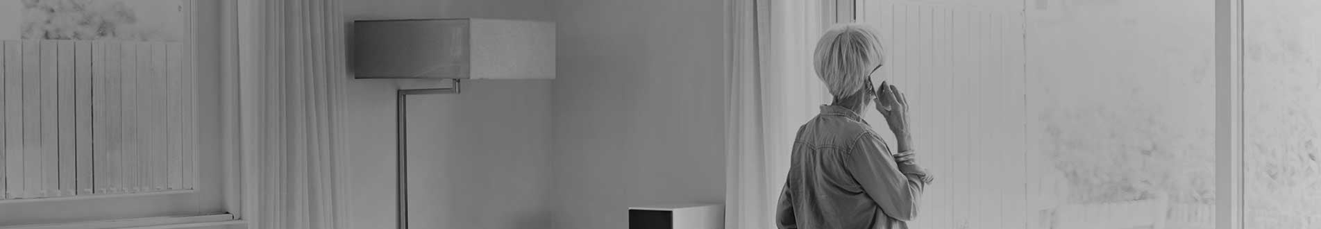 Elderly woman looking out window