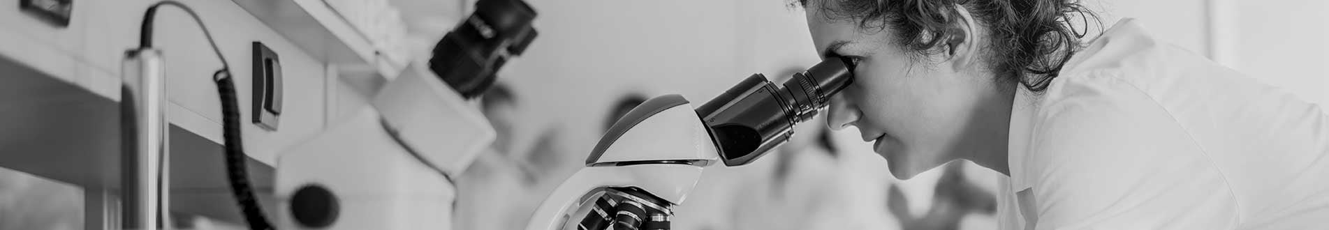 Scientist looking into telescope