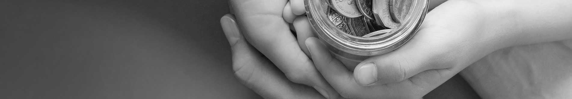 Hands holding jar of money