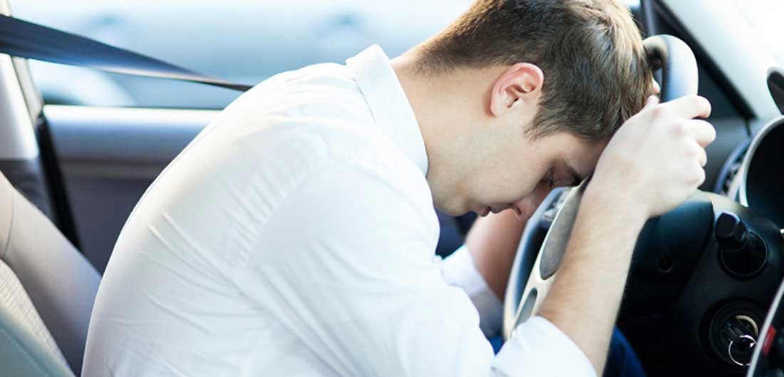 resting head on steering wheel