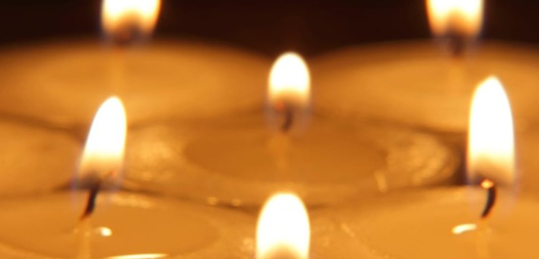 close up of 6 candle wicks burning