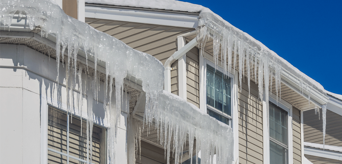 icicles hang from a house's gutters