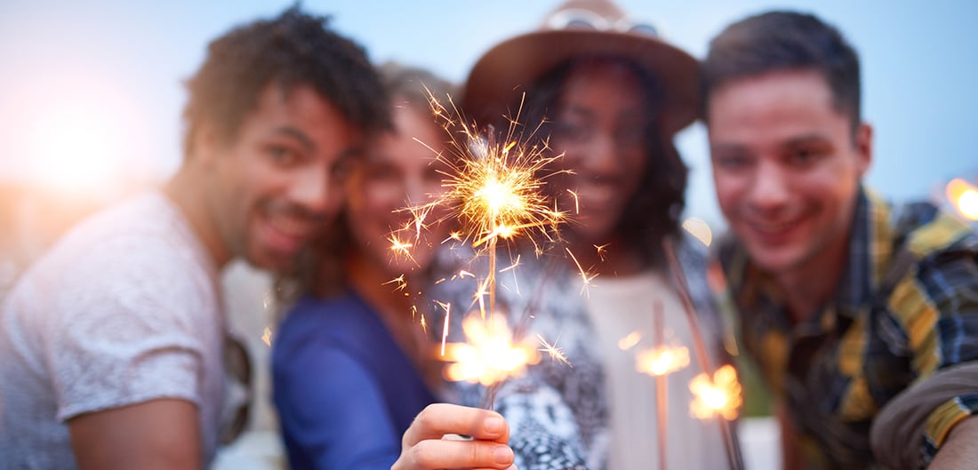 4 people playing with sparklers