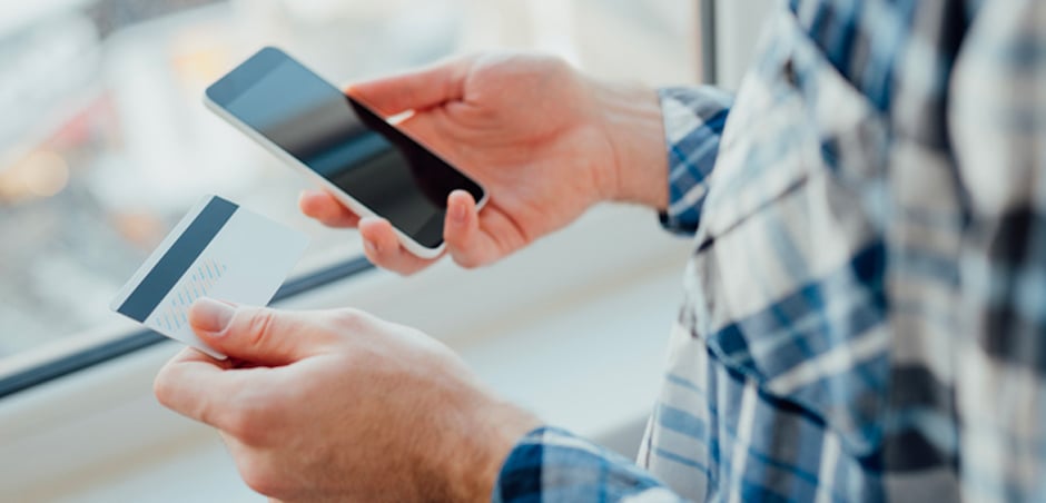 man pays with credit card on smartphone