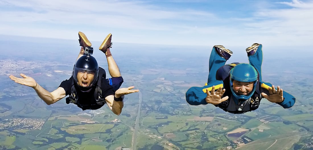 two skydivers fall in midair