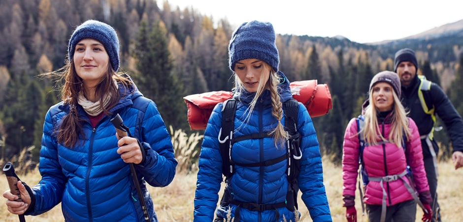 four young adults are hiking