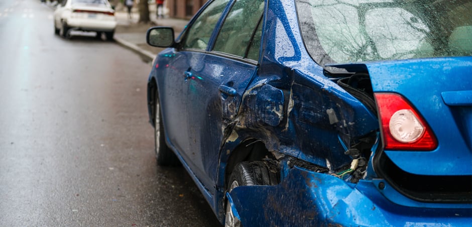 parked car has dent in rear driver's side door