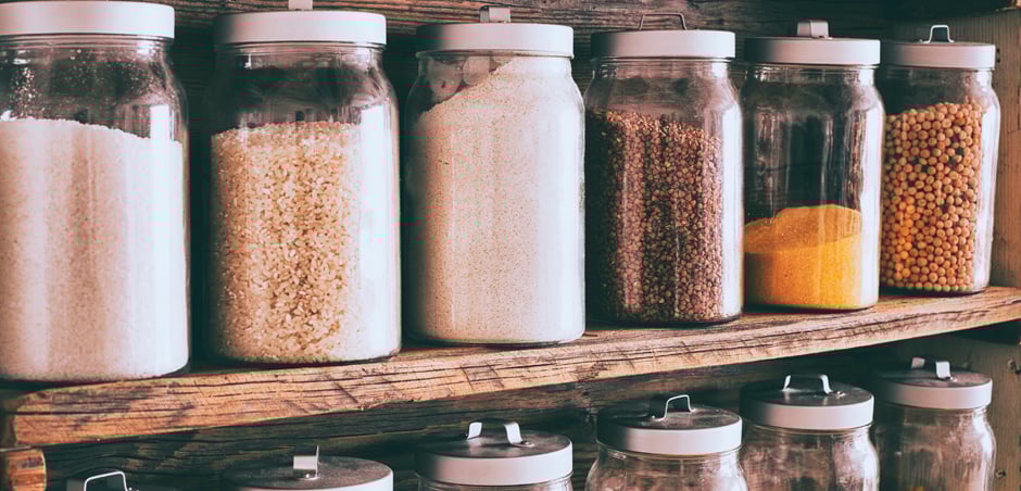 spice jars are lined up in pantry