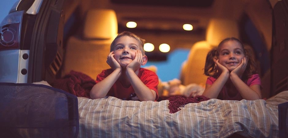 Kids watching movie at drive-in theatre