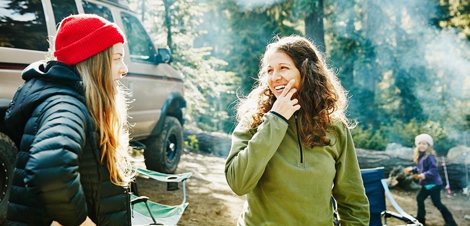 Women standing near an RV