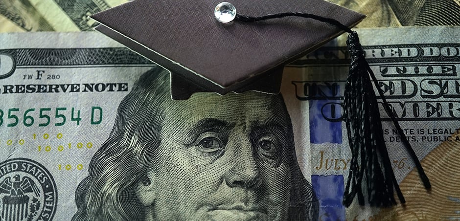 twenty dollar bill with a graduation cap on top