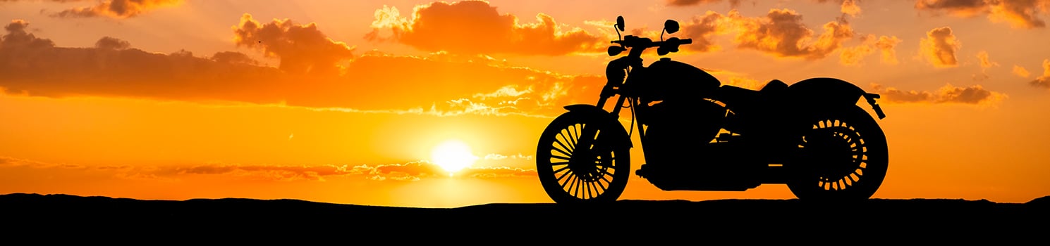 motorcycle against the sunset on the horizon