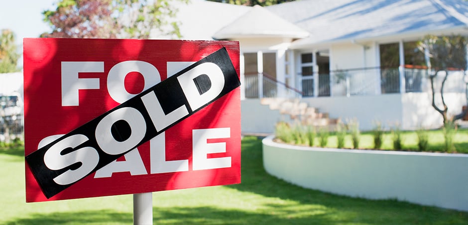 sold house sign in front of a home