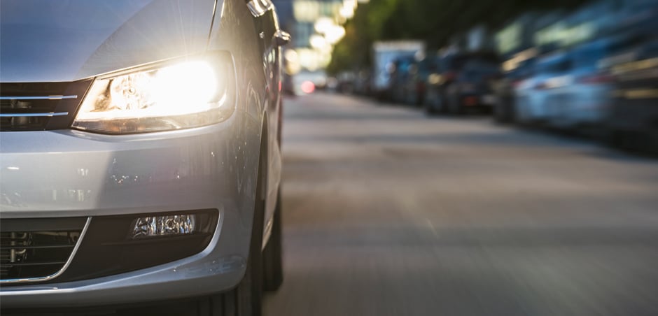 Close up of driver's side headlight on silver sedan.