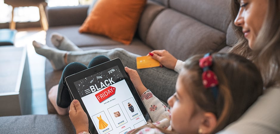 people sitting on a couch with a tablet