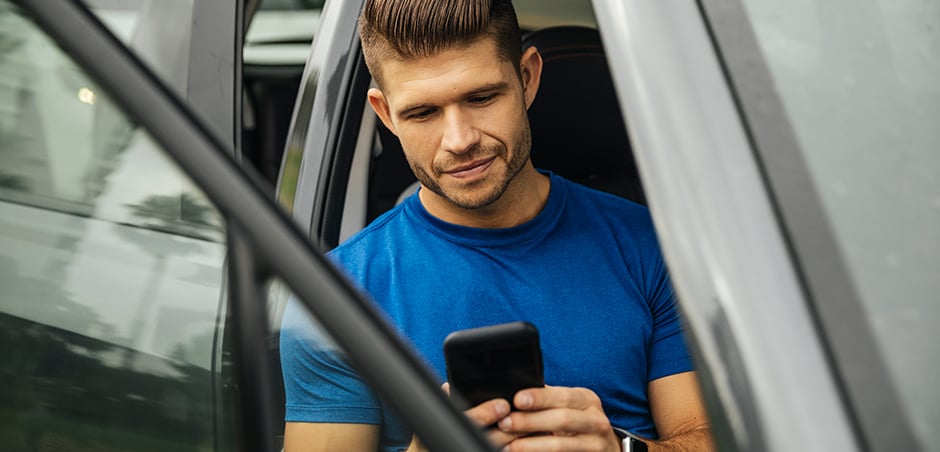 man on phone sitting in car