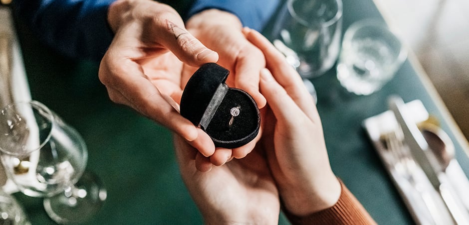 couple holding ring box