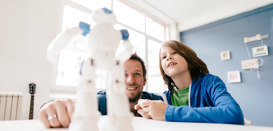 dad and son play with robot