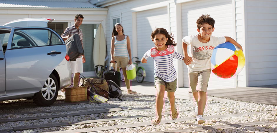 family outside of beach house