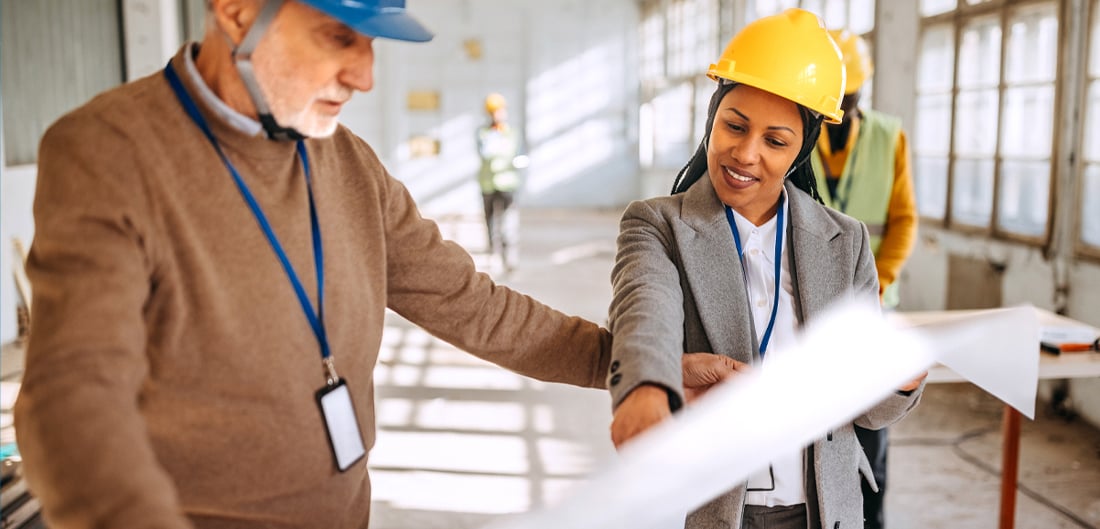 Contractors walking through an office space.