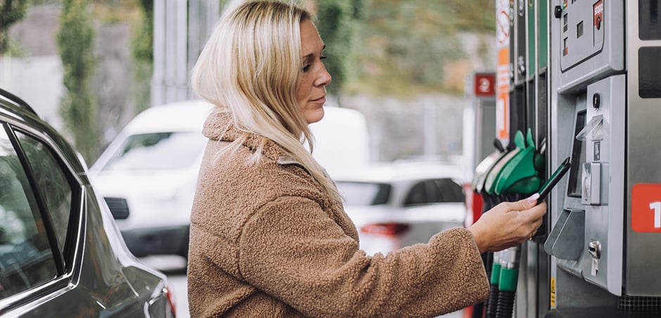 woman standing at gas pump