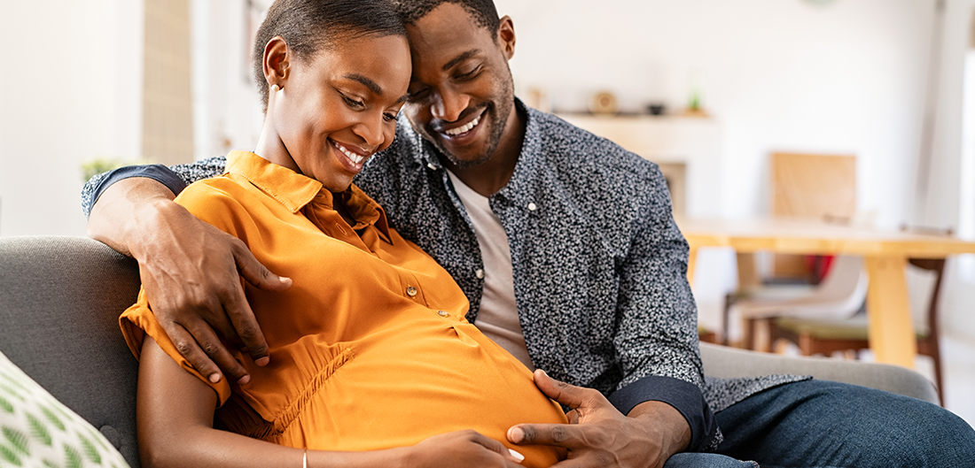 Pregnant woman cuddling man