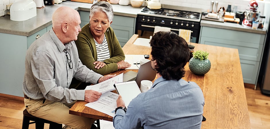Older couple sitting at a table having a discussion