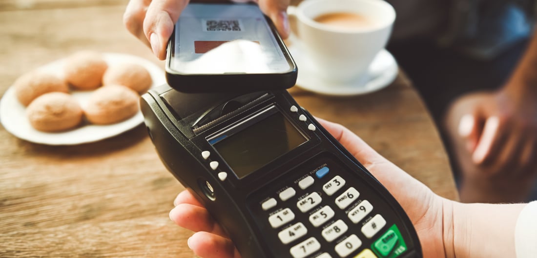 person holding a portable card reader