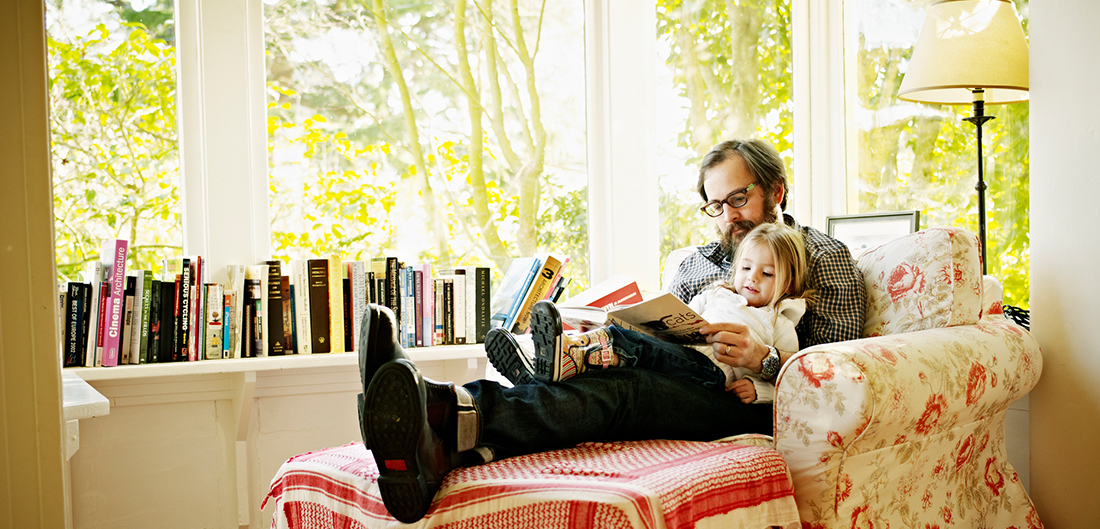 Adult sitting and reading to child