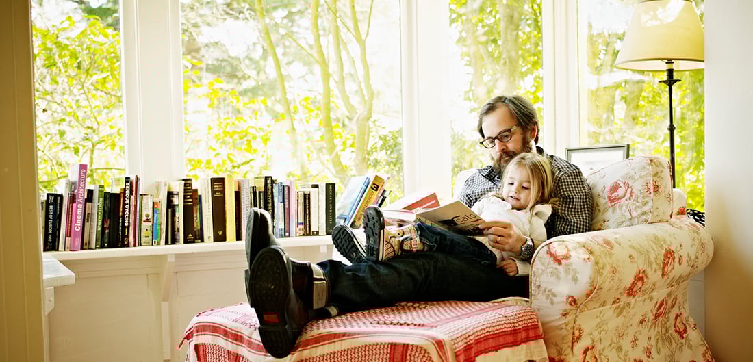 Adult sitting and reading to child