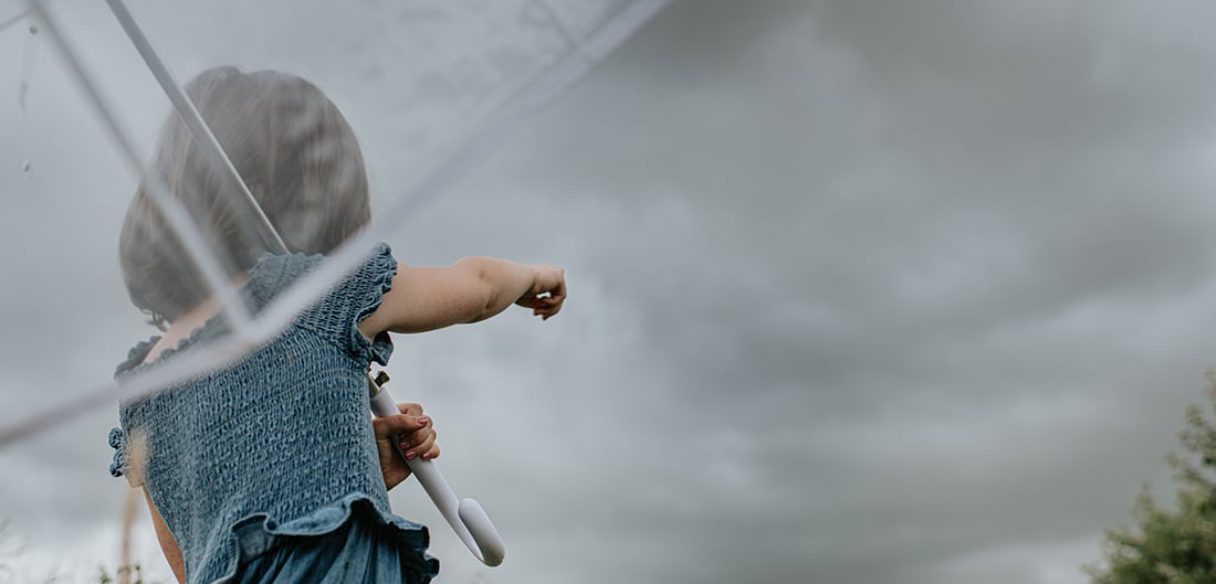 Child pointing at storm clouds