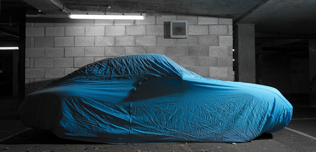 Car under a blue cover